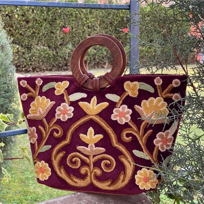 Handcrafted crewel handbag with velvet base